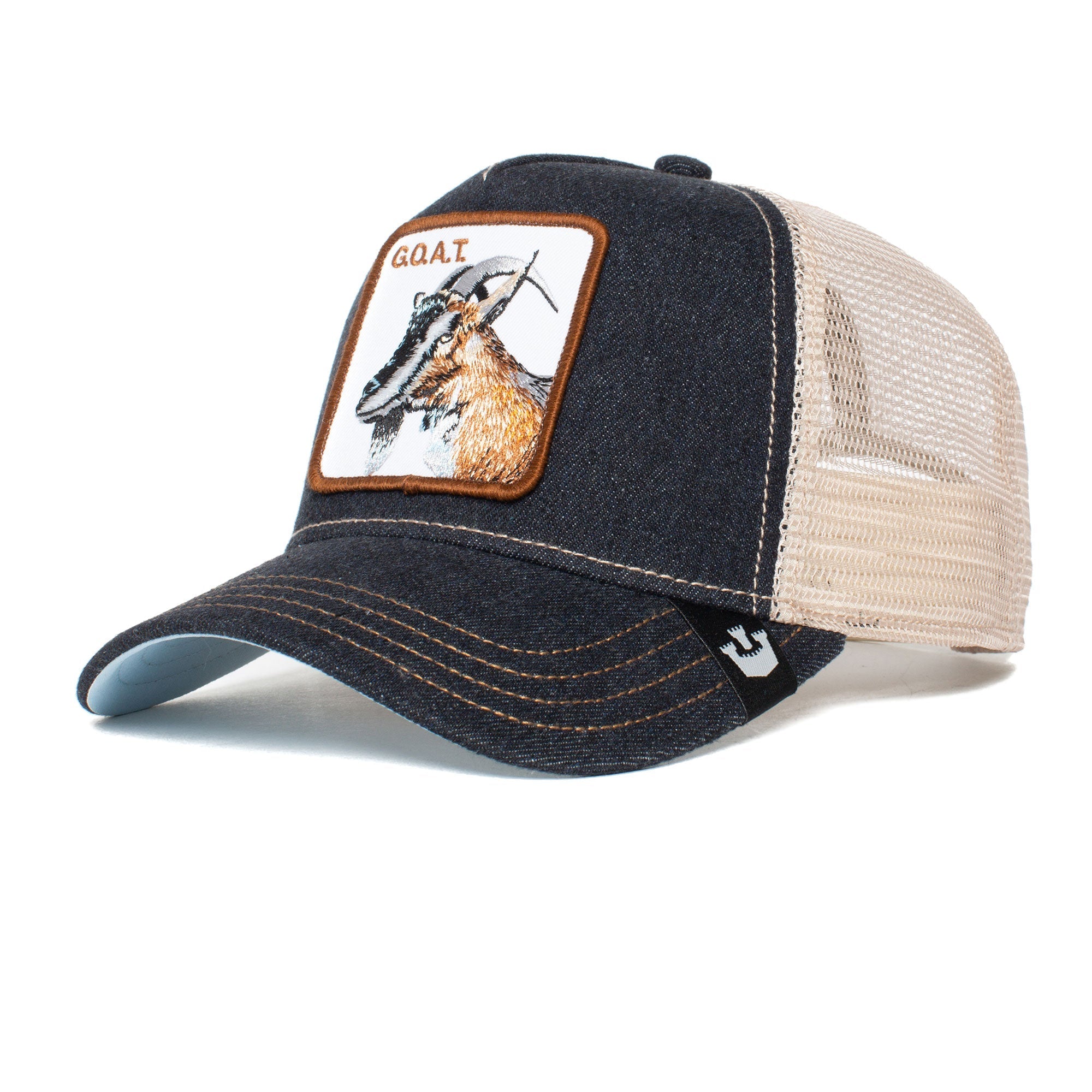The GOAT is a navy and beige mesh trucker hat featuring a stylish goat patch on the front. Colors may fade over time.