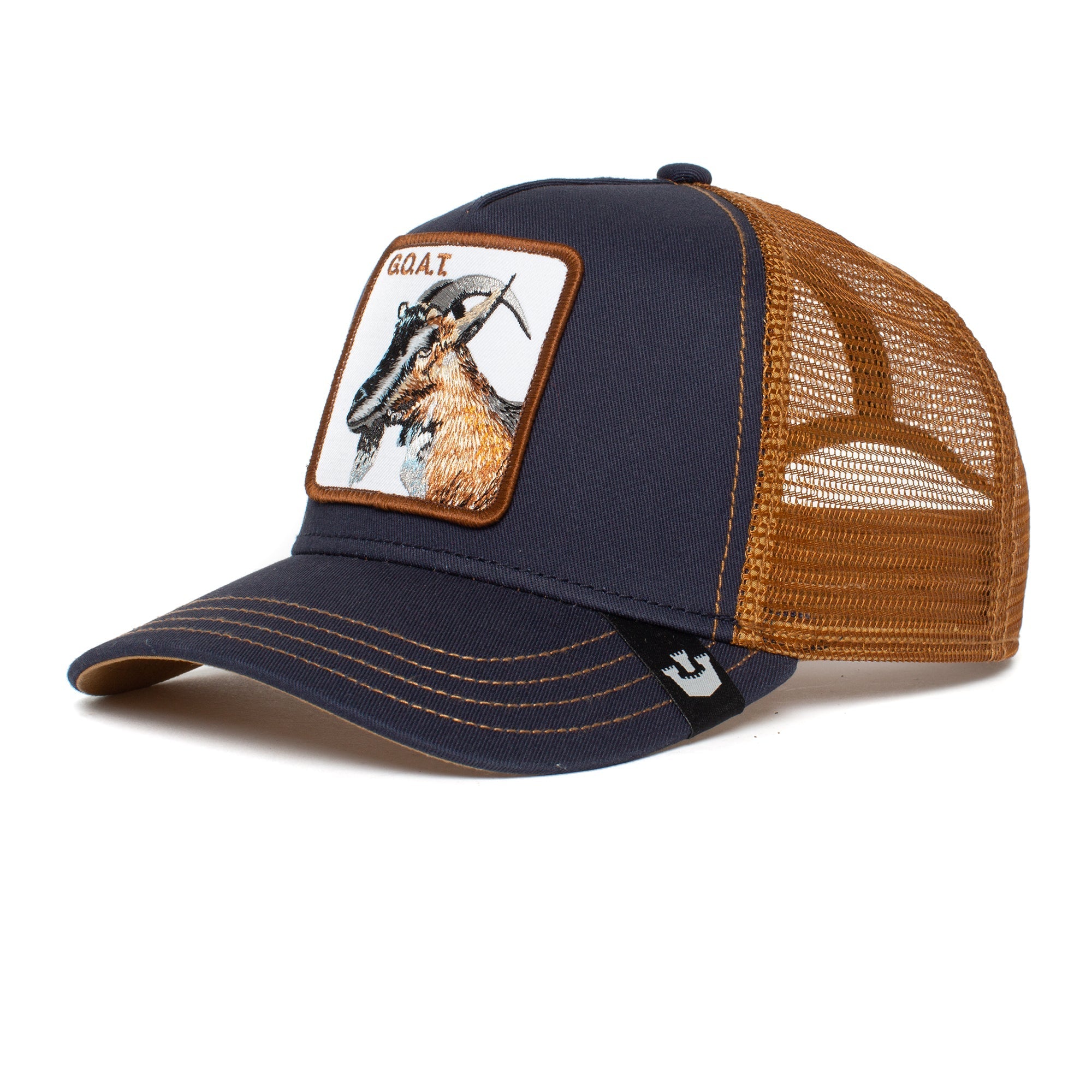 The GOAT is a navy and brown mesh trucker hat featuring a goat patch on the front panel, designed to look even better as its colors fade over time.