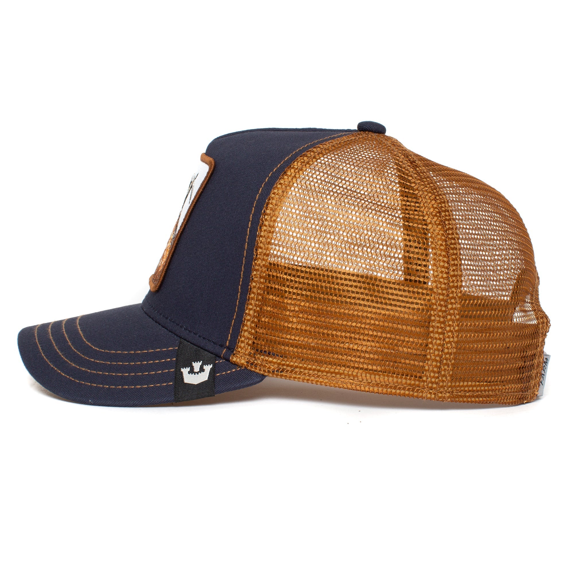 The GOAT navy blue and brown trucker hat features a mesh back and playful patch details on the front and side.