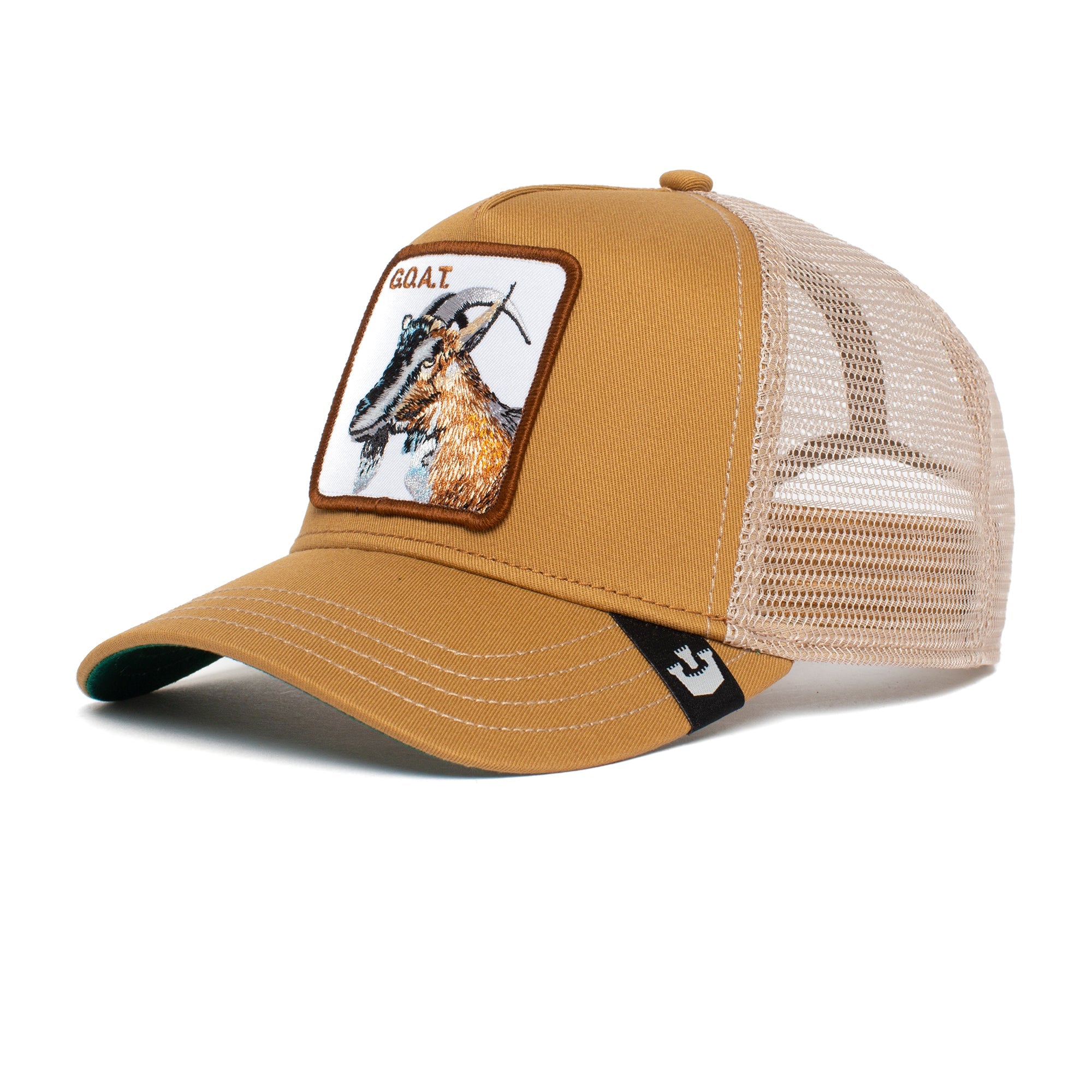 The GOAT is a tan and beige mesh trucker hat with an embroidered goat patch on the front. Colors may gently fade over time.
